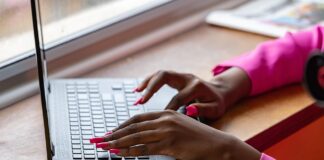 Hands typing on computer