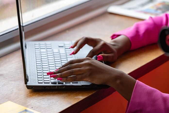 Hands typing on computer