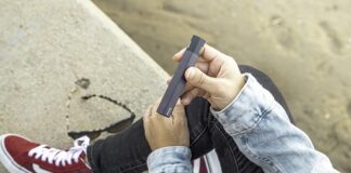 person sitting and holding vape