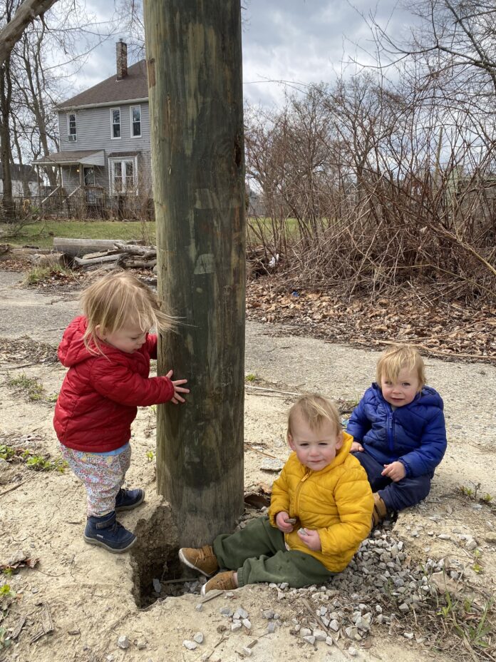Triplets in colored coat at lightpost
