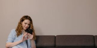 Parent on phone with kid playing