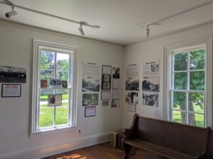 A room containing a timeline and wooden bench.